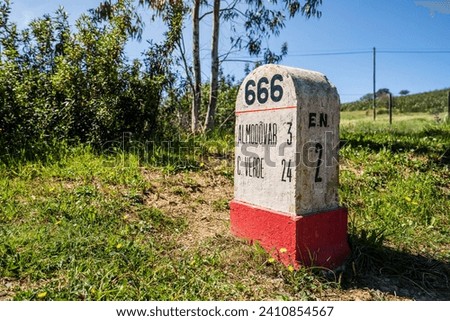 Road milestone indicating 666th kilometer on famous national road N2 going across Portugal Royalty-Free Stock Photo #2410854567