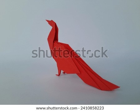 Origami bird on white background