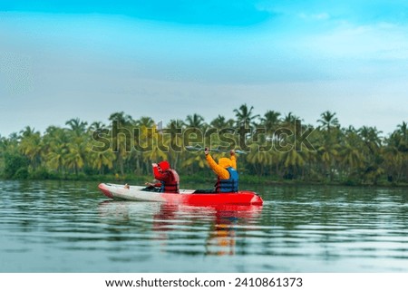 Kayaking in Kerala image, Travel guys kayaking and enjoying the nature view, Kerala travel and tourism concept background Royalty-Free Stock Photo #2410861373
