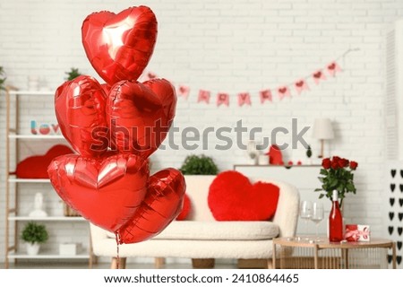 Heart-shaped balloons in living room, closeup. Valentine's Day celebration