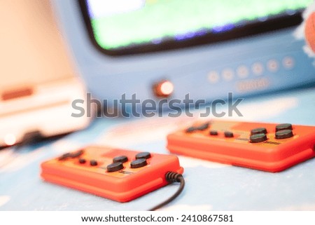 Close-up side view of an old joystick. Retro 80s games placed side by side on a table.