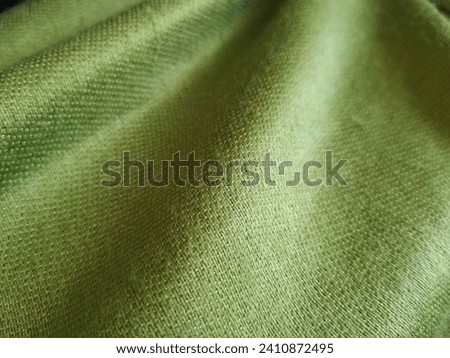 Light green textured fabric background 