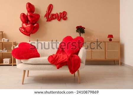 Interior of stylish festive living room with heart-shaped balloons and roses bouquet. Valentine's Day celebration Royalty-Free Stock Photo #2410879869