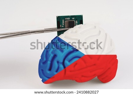 On a white background, a model of the brain with a picture of a flag - Czech, a microcircuit, a processor, is implanted into it. Close-up