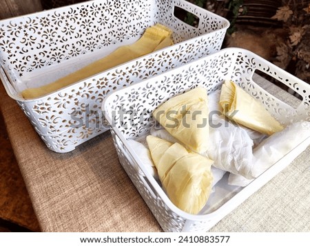 Plastic bag folded into triangle for storage. Ways of storing and laying at home Royalty-Free Stock Photo #2410883577