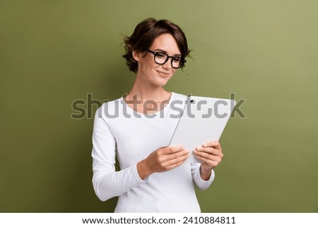 Photo portrait of lovely young lady boss hold tablet worker manager dressed white garment isolated on khaki color background