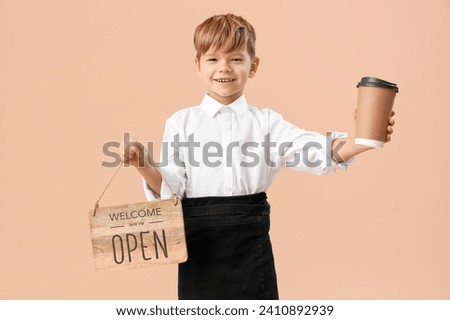 Cute little waiter with coffee cup and OPEN sign on beige background. Opposite Day celebration