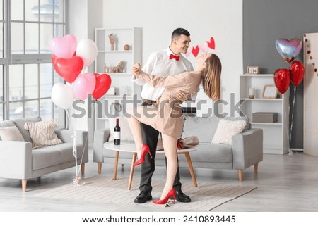 Beautiful young couple dancing and celebrating Valentine's Day at home