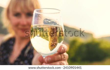 A woman drinks wine against the backdrop of mountains. Selective focus. travel.