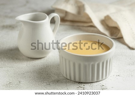 Fresh condensed milk in the bowl. Royalty-Free Stock Photo #2410923037