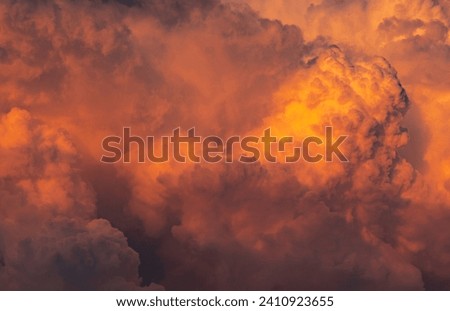 Dramatic orange sky and clouds abstract background. Top view of orange clouds. Warm weather background. Art picture of orange clouds texture.