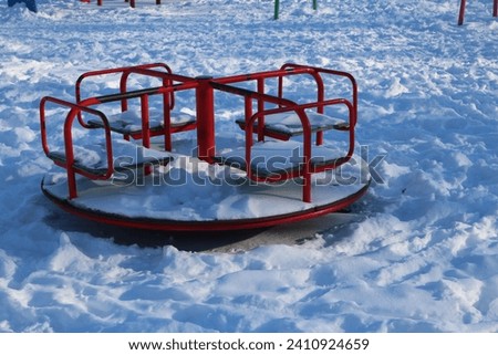 A red slide in the snow Royalty-Free Stock Photo #2410924659