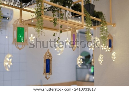 hanging crescent moon ornamental decoration for crescent moon decoration with soft white cotton and small blinking lamps for special holiday seasonal ramadan or valentine day decoration Royalty-Free Stock Photo #2410931819