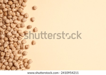 Raw chickpeas on colored background. Healthy and natural vegetarian food Royalty-Free Stock Photo #2410954211