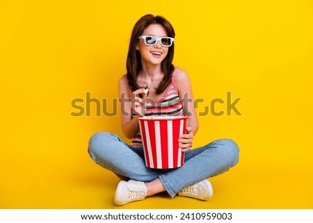 Full size photo of cheerful woman dressed knitwear top in 3d glasses sit eat popcorn watch comedy isolated on yellow color background