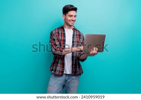 Photo of cheerful confident man dressed plaid shirt looking communicating apple iphone modern gadget isolated turquoise blue color background