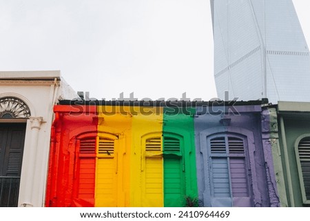 Brightly painted with colored paint the wall of the house from the bottom