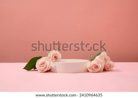 Roses are decorated around a podium on a pink background. Ideal space for cosmetics display. Beauty theme for advertising. Copy space with front view.