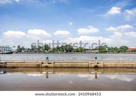 A picturesque scene of a bridge spanning across a calm body of water. Royalty-Free Stock Photo #2410968453