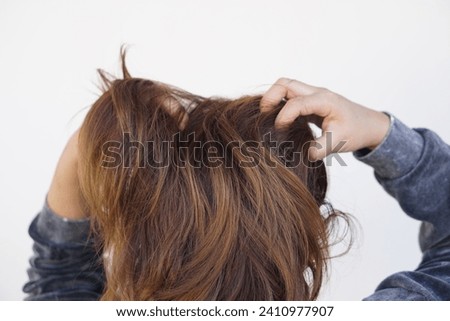 Woman use hands to scratch her itcy hair on head, isolated on white background. Concept, Hair health problems. Dandruff, fungus on scalp, allergic to shampoo or louse.                                 