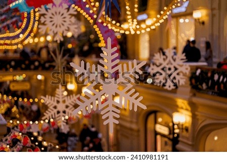 Christmas illumination and decoration with Snowflakes, golden lights bokeh, city shopping mall
