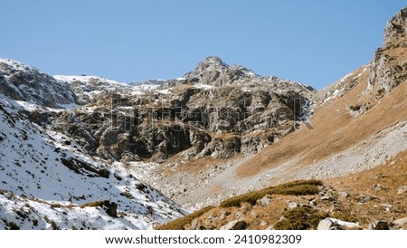 Panoramic view of the mountains between the seasons of autumn and winter at the sunny day, beautiful landscape of mountain peaks on Arkhyz, Sofia Valley, Caucasus Mountains