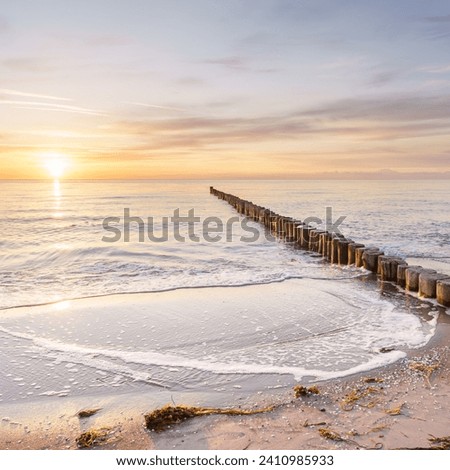 Sunset on the Baltic Sea beach Royalty-Free Stock Photo #2410985933