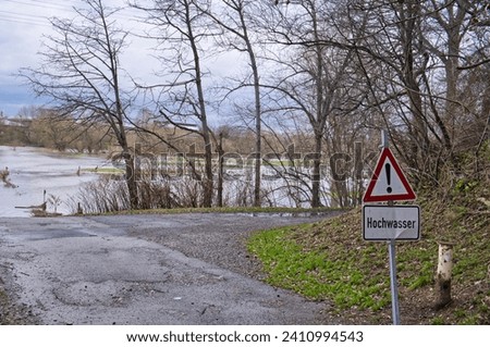 Flooding of the banks of the Sieg River with information signs with the German inscription Flood in Troisdorf, Siegburg, Germany