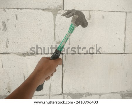 The skill of a builder using a hammer.  Hammering nails in the wall