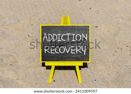 Addiction recovery symbol. Concept words Addiction recovery on beautiful black chalk blackboard. Beautiful sand sea beach background. Psychology addiction recovery concept. Copy space.