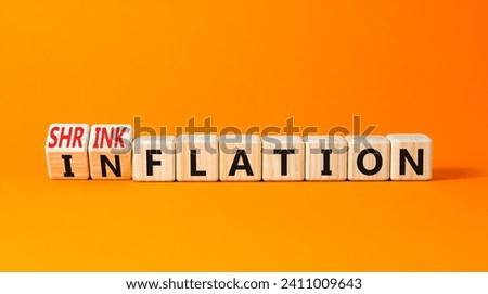 Inflation or shrinkflation symbol. Concept words Inflation Shrinkflation on beautiful wooden blocks. Beautiful orange table orange background. Business inflation shrinkflation concept. Copy space Royalty-Free Stock Photo #2411009643
