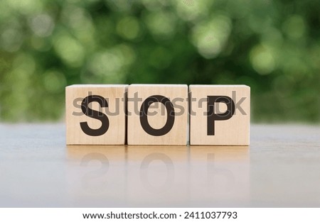 SOP - acronym from wooden blocks with letters, abbreviation SOP standard operating procedure concept, blur background Royalty-Free Stock Photo #2411037793