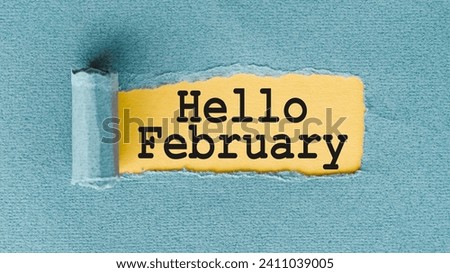 HELLO FEBRUARY words written under ripped and torn paper. Royalty-Free Stock Photo #2411039005