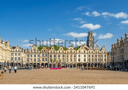 Flemish-Baroque-style townhouses buildings on La Petite market Place des Heros Heroes Square in Arras historical city center, blue sky in summer day, Artois, Pas-de-Calais department, Northern France Royalty-Free Stock Photo #2411047691