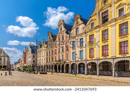 Flemish-Baroque-style townhouses buildings on La Grand Place square in Arras historical city center, blue sky in summer day, Artois, Pas-de-Calais department, Hauts-de-France Region, Northern France Royalty-Free Stock Photo #2411047693