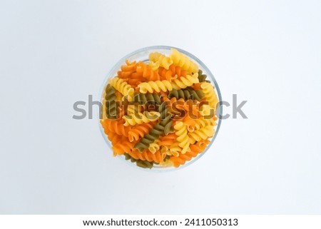 Heap of raw tricolor Fusilli gluten free pasta stock photo