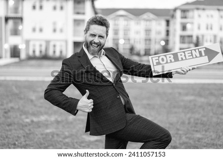 photo of renter adviser man with for rent sign, thumb up. rent property by renter adviser man.