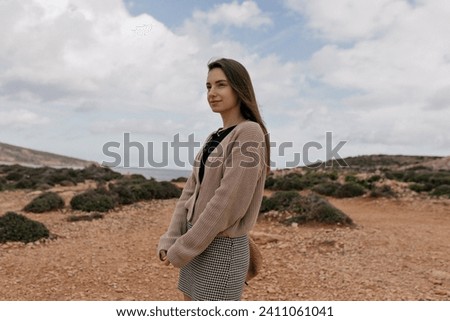  Outdoor photo of european stylish brunette girl traveling among the mountains against blue sky
