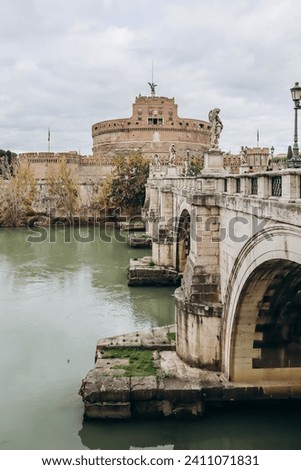 St. Angelo Bridge and Castel Sant'Angelo in Rome on a cloudy December day Royalty-Free Stock Photo #2411071831