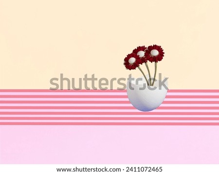 Flowers with Easter eggs in an eggshell on a pink and yellow striped background. Minimal Easter pattern.