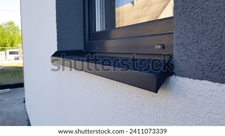 Metallic window sill on the house Royalty-Free Stock Photo #2411073339