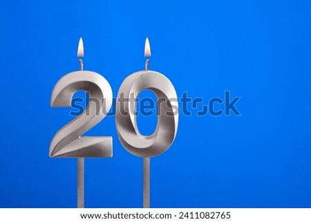Birthday number 20 - Candle lit on blue background