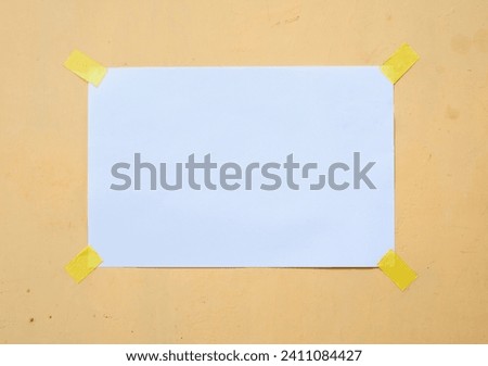 Blank white paper note with tape isolated