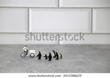 Miniature Ice Cream Vendor taking Orders from Group of Tiny Penguins.