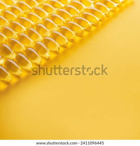 Square banner with vitamin D3 capsules on yellow background. Concept of the production of pharmaceuticals. Selective focus, copy space