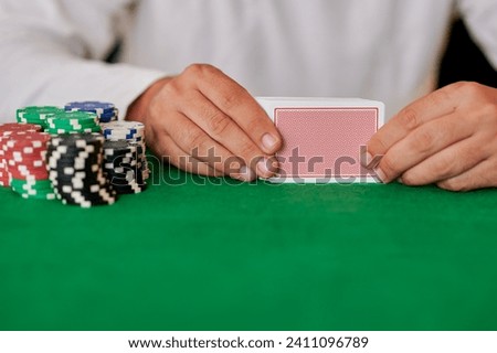 Closeup of hands with cards in casino Royalty-Free Stock Photo #2411096789