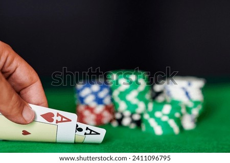 Man's hand with two aces in casino Royalty-Free Stock Photo #2411096795