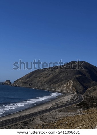 From a high sand hill in Malibu you can see the beautiful landscape and mountains surrounding the ocean