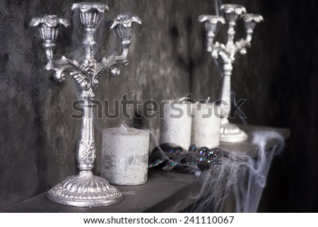 Tarantula Spider on Eerie Cobweb Covered Mantle with Candles and Candelabras in Haunted House Setting