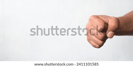 portrait of man's hand clenching fist isolated white background